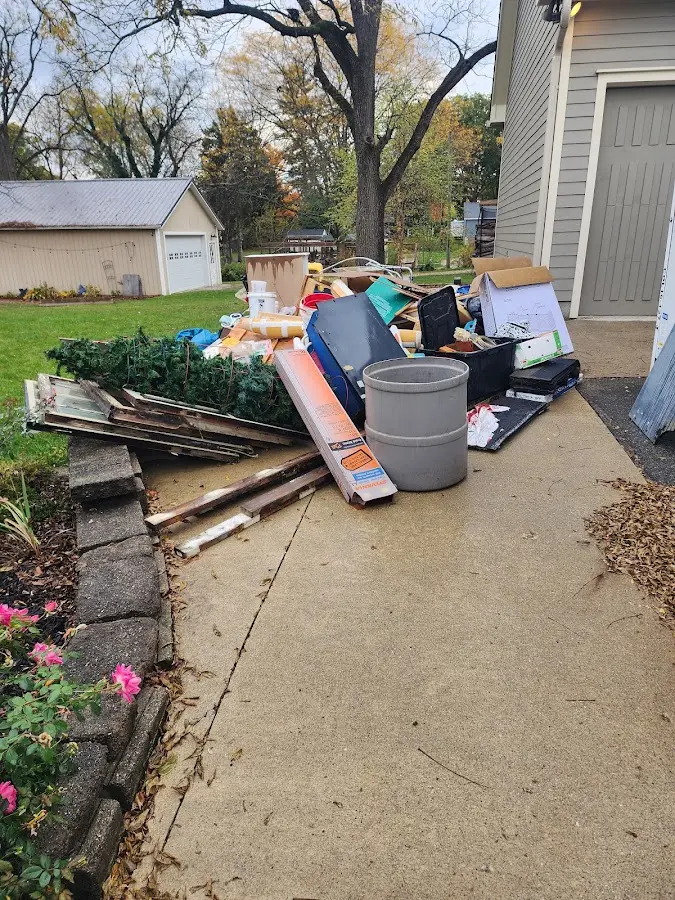 Dumpster being loaded with debris for 3 Yard Dumpster Rental in Robbinsdale